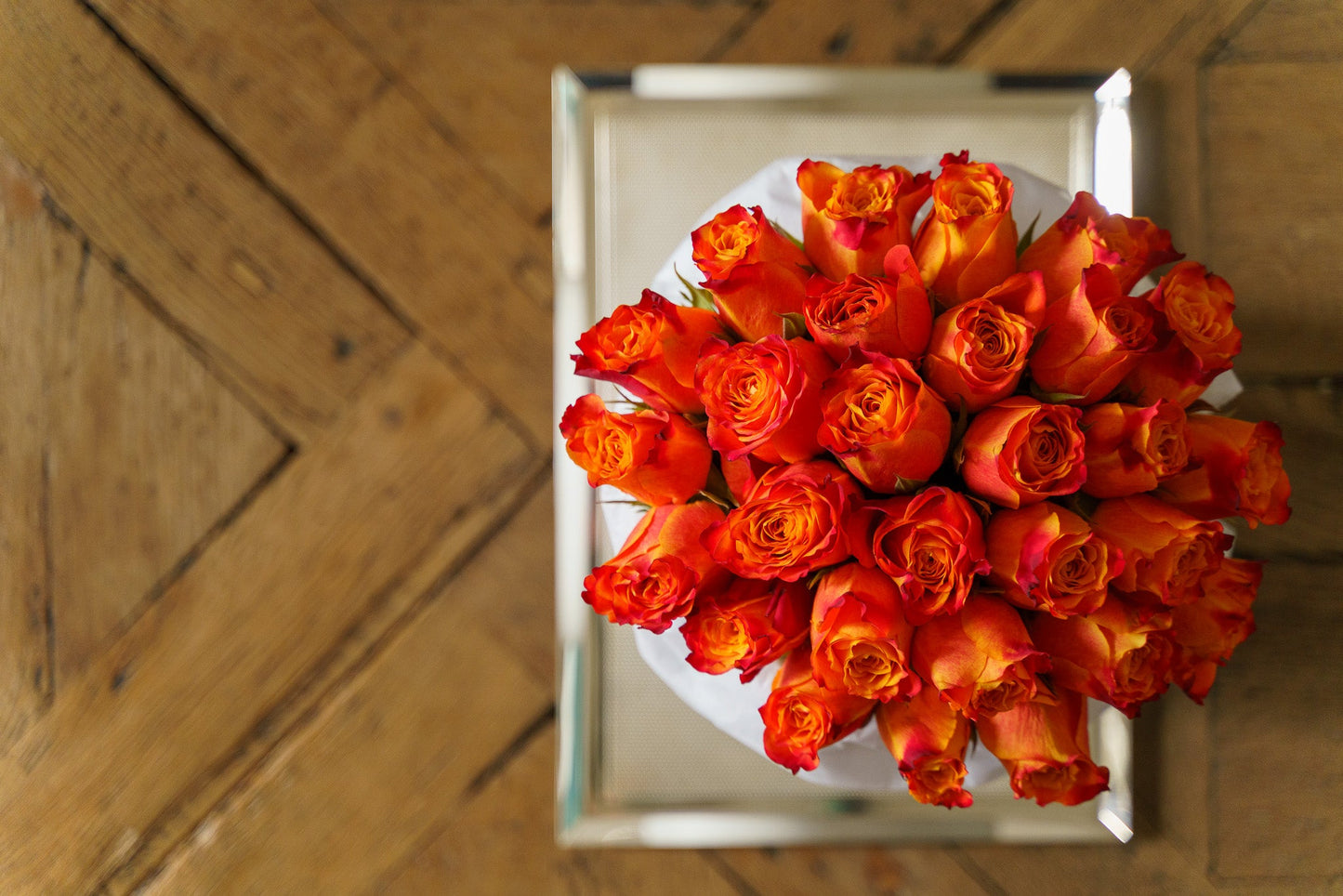 Bright orange roses in elegant gift box